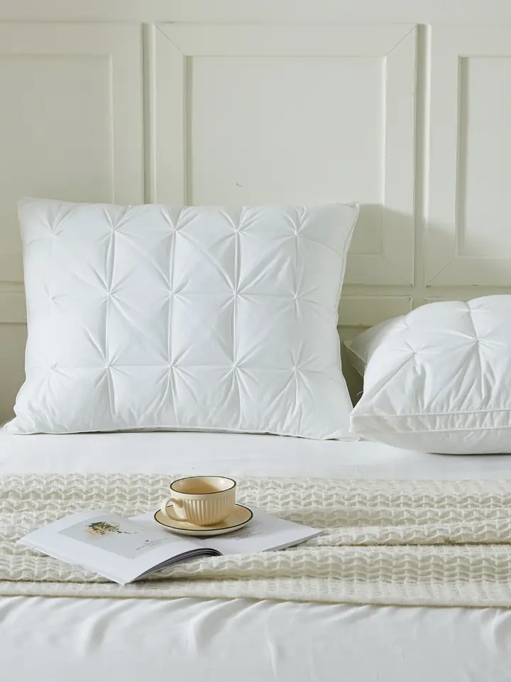 Pin-tucked white pillows